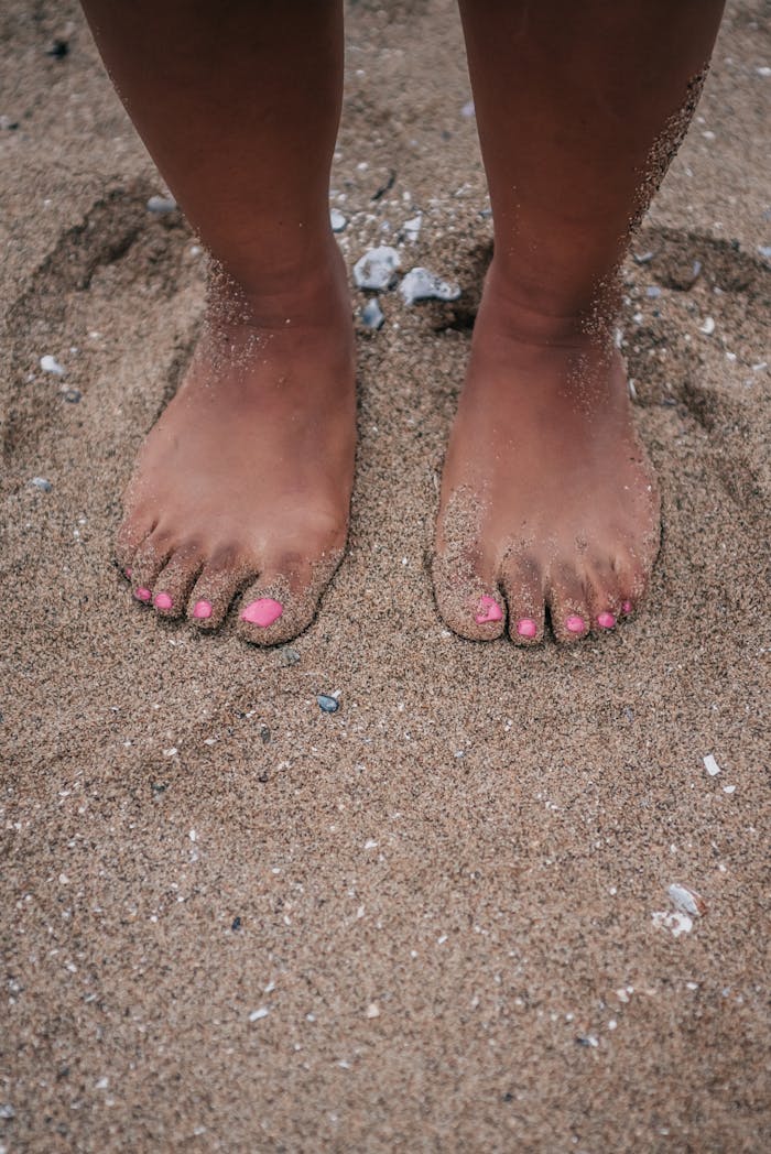 Close-Up Shot of a Persons Feet on the Sand